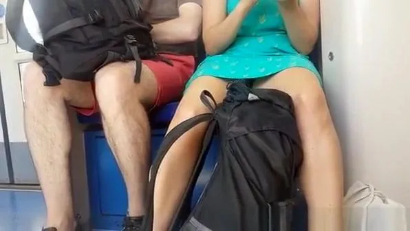 Woman in dress upskirted in train