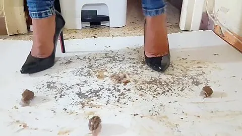 Latin babe crushing snails in high heels.