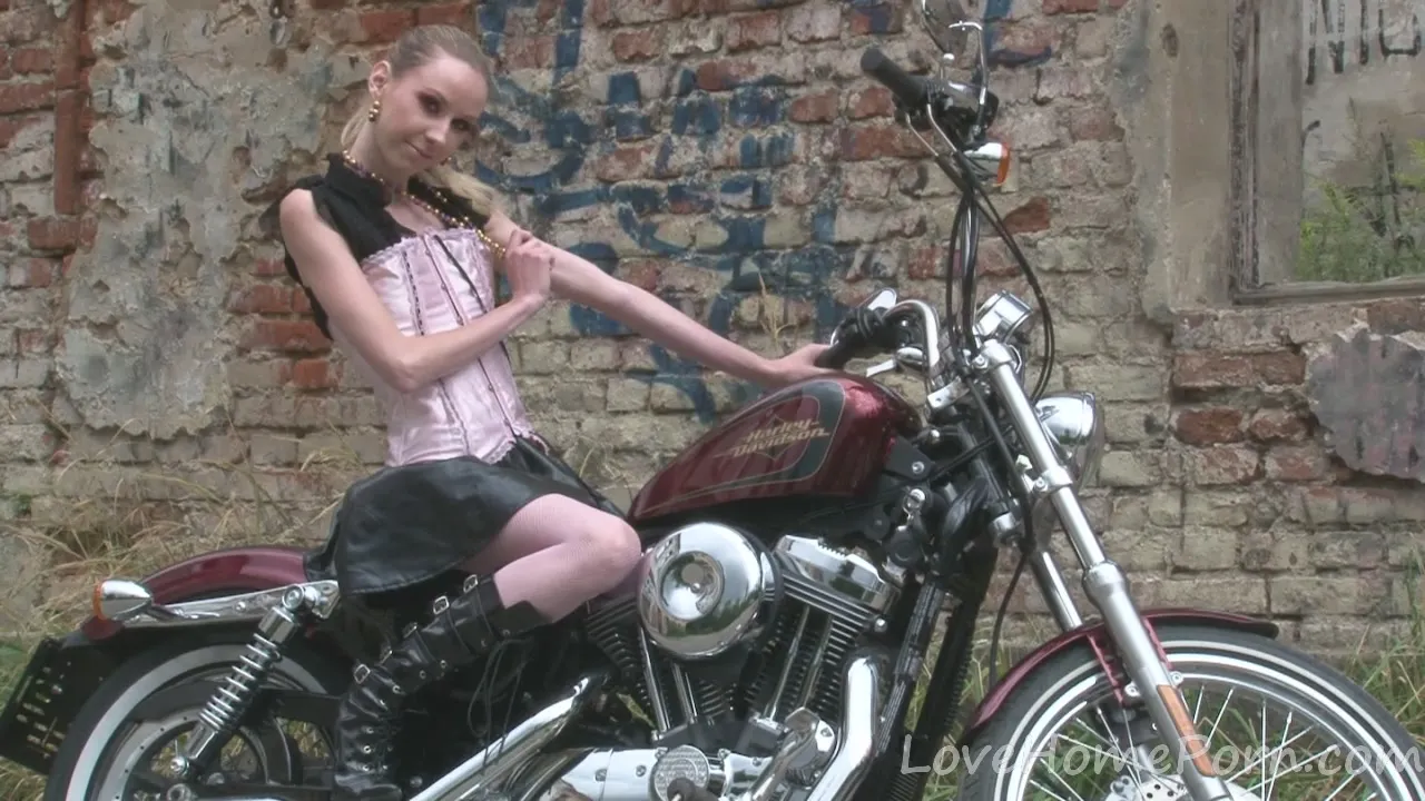 Cute teen 18+ is amazed by a big bike