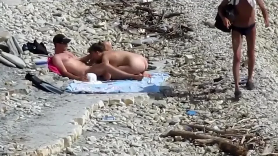 Sensual girl jumps on her boyfriend's fat dick at the nude beach