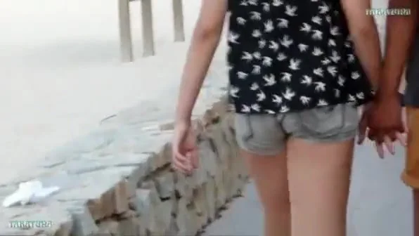 Girl in tight shorts curls ass.