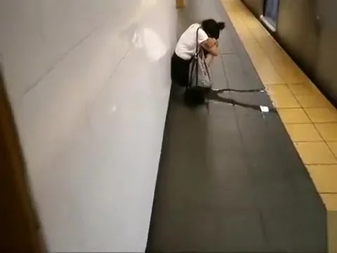 coed relieves herself at a metro station