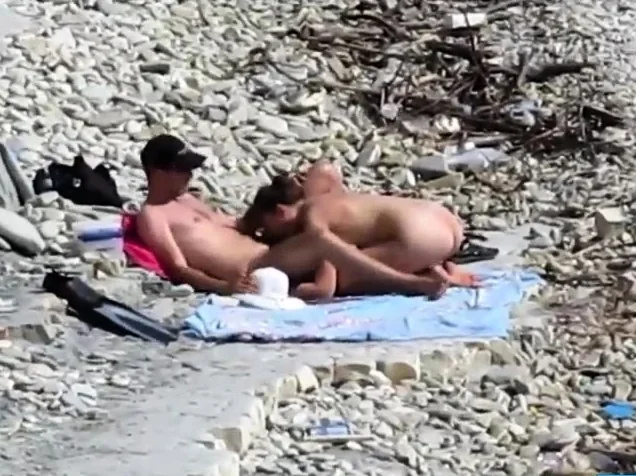 Couple fucked on a public beach while as people walked near