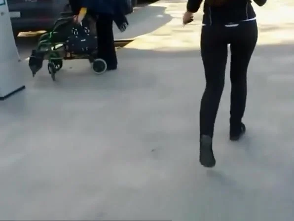 Long hair redhead in tight black sports pants