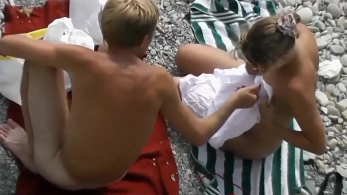 Naked Couple Playing On The Beach