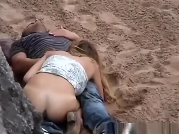 Horny chick riding cock in public beach