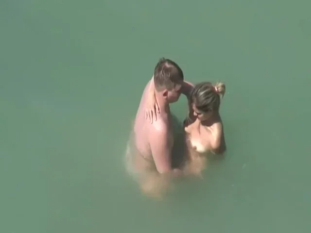 Beach couple sex in the sea
