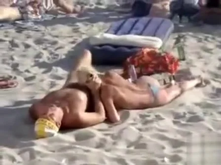 Doing the fellatio on a crowded beach