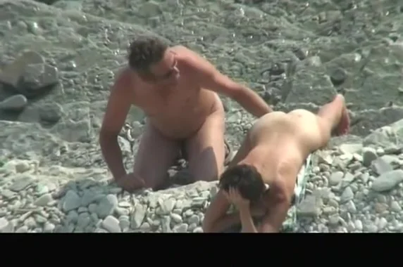 Nude couple spied in rocky beach
