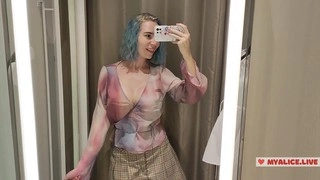 Trying on sheer outfits in the mall dressing room for a seductive show