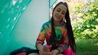 Hippie chick with black hair gives a free handjob in a tent